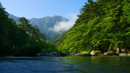 Tranquil mountain river flowing through a lush green forest with misty peaks in the background, representing peace, nature, and wilderness.