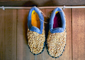 Retro bast shoes hung on the wall 