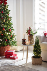 Beautiful Christmas tree and other decor in spacious room. Festive interior design