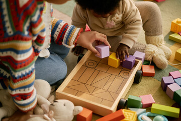 Toddler Playing With Colorful Wooden Blocks on Floor