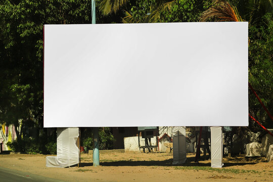 billboard on city road, outdoor advertising, mockup billing board in front of green tree and Blank white background for branding design large hoarding, Outdoor advertising construction. india.