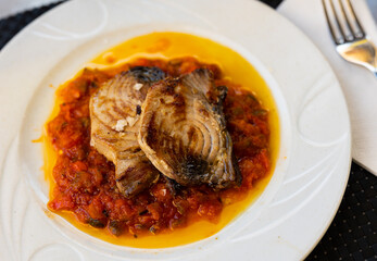 Stewed tuna fish with vegetables and samfaina sauce served on platter