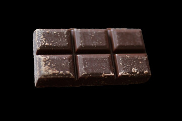 A sleek dark chocolate bar made up of six perfectly aligned squares. Each piece displays a smooth, glossy surface with subtle patterns. 