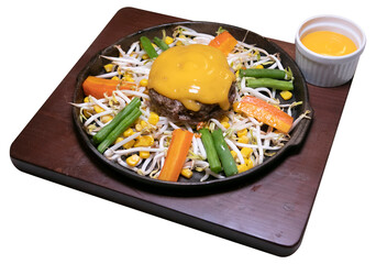 cheese sauce beef hamburg with vegetables on a hot plate
