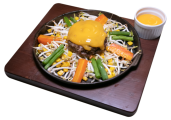 cheese sauce beef hamburg with vegetables on a hot plate
