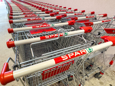Row of spar shopping carts in supermarket aisle
