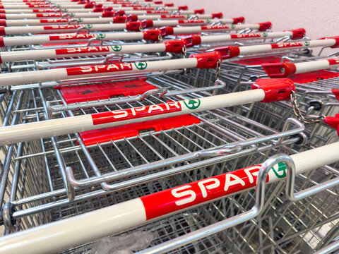 Rows of spar shopping carts neatly arranged at supermarket entrance