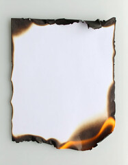 A partially burned sheet of paper with jagged edges, showcasing the effects of fire, set against a neutral background