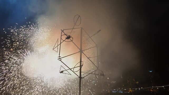 Sparkling spiral rotating bright fireworks formation at the Marsaskala village festa in Malta.