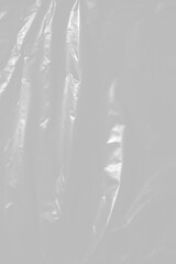 plastic overlay texture of realistic crumpled transparent plastic film wrap on black background,wrinkled stretched plastic effect.	