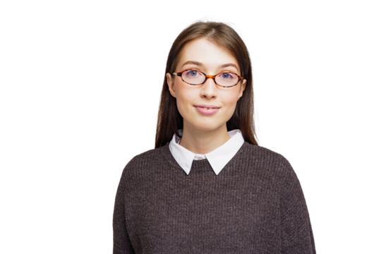 Young professional wearing glasses smiles confidently against a minimalist backdrop while dressed casually