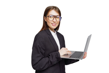 Confident professional woman engages with her laptop while wearing stylish glasses in a modern office setting