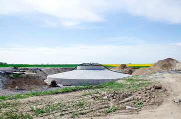 Construction site and agriculture field. Preparation of a wind turbines with concrete and steel. building wind turbines. wind turbine base and Pile of sand and Gravel for construction.