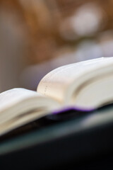 An open holy book rests at the front, gazing out over the church, where the chandelier glimmers above the nave