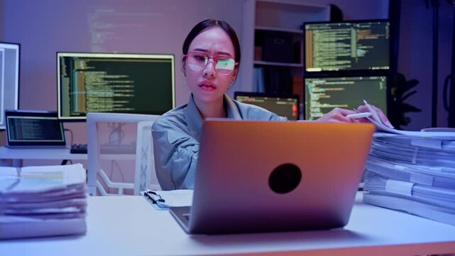 frustrated young woman clutches her head in stress while surrounded by towering stacks of documents, highlighting workplace pressure due to lack of AI, RPA, and DMS systems for automation.