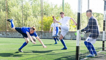 Football player hits ball with his head towards the goal