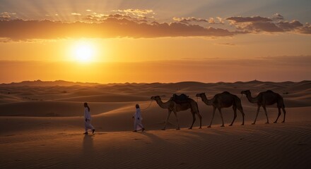 Photo of Camels Walking Across the Desert at Sunset with Silhouetted Figures