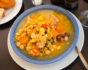 Traditional Spanish dish cocido chickpea stew with meat and vegetables