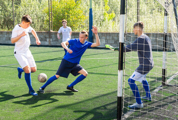 Football game - defender knocks ball from the attacker