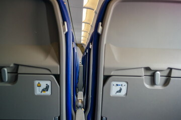 Seat backs in an airplane, close-up. Spacing between rows of seats on low-cost airlines