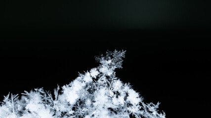 Beautiful snowflakes creating a winter wonderland with intricate frozen ice crystals on a dark...