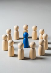 Obraz premium Blue wooden figure stands out in a circle of beige figures illustrating individuality