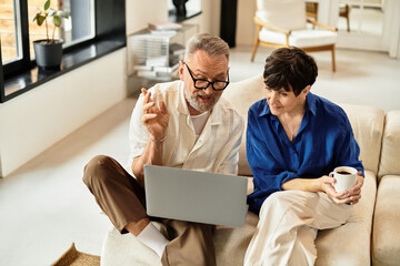 Joyful couple sharing moments together while exploring ideas at home