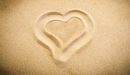 Heart Drawn in Soft Beach Sand – Summer Fun and Vacation Symbol. Sand background with copy space..