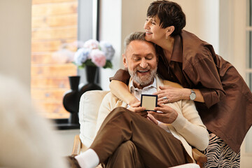 Middle aged couple celebrates love and joy at home in a warm and cozy moment together