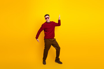 Fototapeta premium Cheerful Young Man Posing in Stylish Attire Against Vibrant Yellow Background