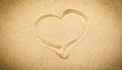 Heart Drawn in Soft Beach Sand – Summer Fun and Vacation Symbol. Sand background with copy space..