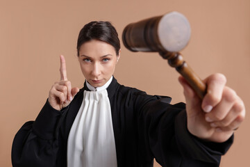 Judge with mallet on light brown background