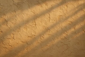A natural textured clay wall in warm tones, lit by soft diagonal shadows, creating a handcrafted, Mediterranean-style ambiance.