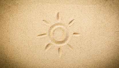 Sun Drawn in Soft Beach Sand – Summer Fun and Vacation Symbol. Sand background with copy space.