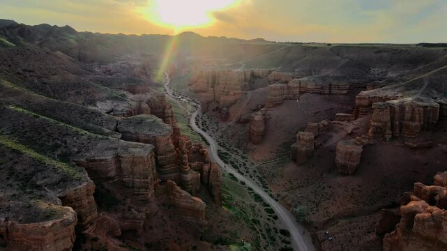 Aerial sunset view of Charyn Canyon in Kazakhstan
Majestic drone footage of Charyn Canyon during golden hour in Kazakhstan. The camera glides smoothly above the rugged cliffs and winding formations
