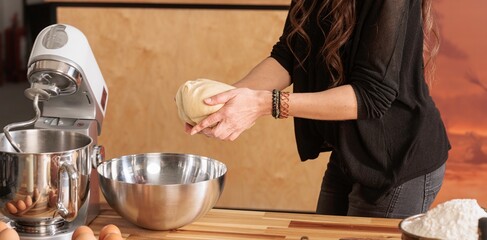 In a warm, minimal kitchen, a young girl kneads dough with flour-covered hands, embodying the joy of learning and nostalgia. Each movement reflects a deep connection to heritage and family traditions
