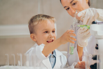 The boy looks enthusiastic, learning in the laboratory. Real People The Boy Education Laboratory.