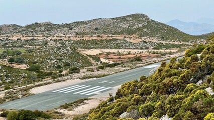 A small airport runway stretches between hills on Kastellorizo Island, Greece. Remote island...