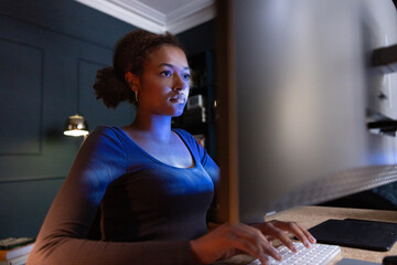 Serious young Woman Working on a Computer at night