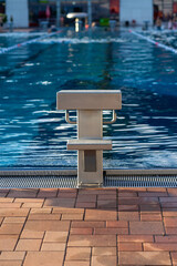 View of the starting block in the outdoor pool against the background of water