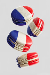Levitating Decorated French Macarons In Motion Falling Down in Air on Empty White Background