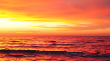 Obraz premium A dramatic sunset over a calm ocean horizon, with warm orange and pink tones reflecting on the water, gentle waves, and a wide-angle view of the open sky, peaceful and emotional