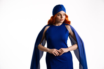 Woman in Elegant Blue Outfit with Turban and Long Cape