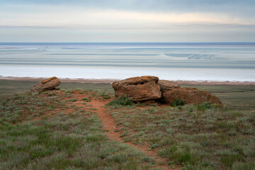 Fancy stones on the slopes of Bolshoe Bogdo Mountain and the salt lake Baskunchak in the distance...