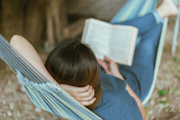Happy young woman relaxing in a hammock