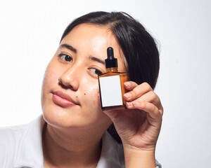 South East Asian Indonesian Women Showcasing Natural Skin Care Routine With Pimple Face Condition During Indoor Session