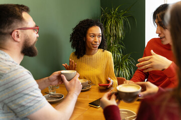 Friends enjoying coffee and conversation at a cafe