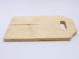 Plain wooden cutting board with a handle slot, isolated on white background