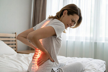 woman with back lumbar pain from bad night sleep
