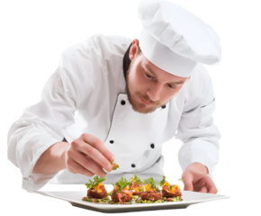 A skilled chef carefully plates an assortment of gourmet appetizers with fresh garnishes for service.
